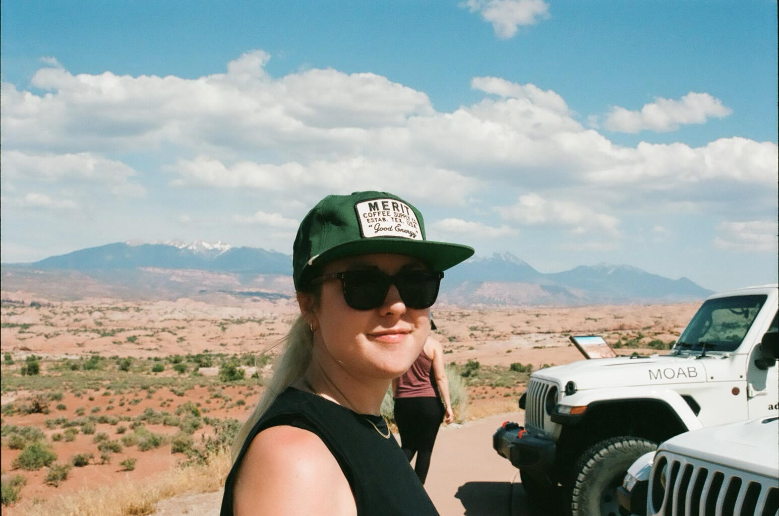 Photo of a woman in sunglasses and a hat with a background of the desert and mountains. Meredith Garreau is a virtual creative mental health therapist who sees clients in Texas, Montana, and Tennessee.